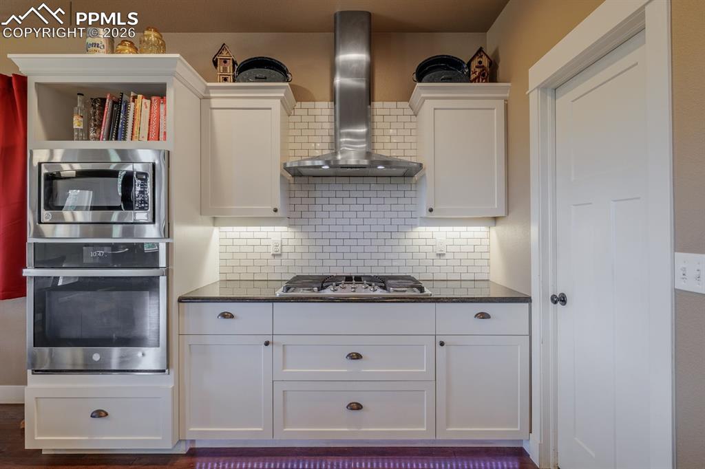 Gas grill with a real vented hood to the outside. Pantry door is on the right.