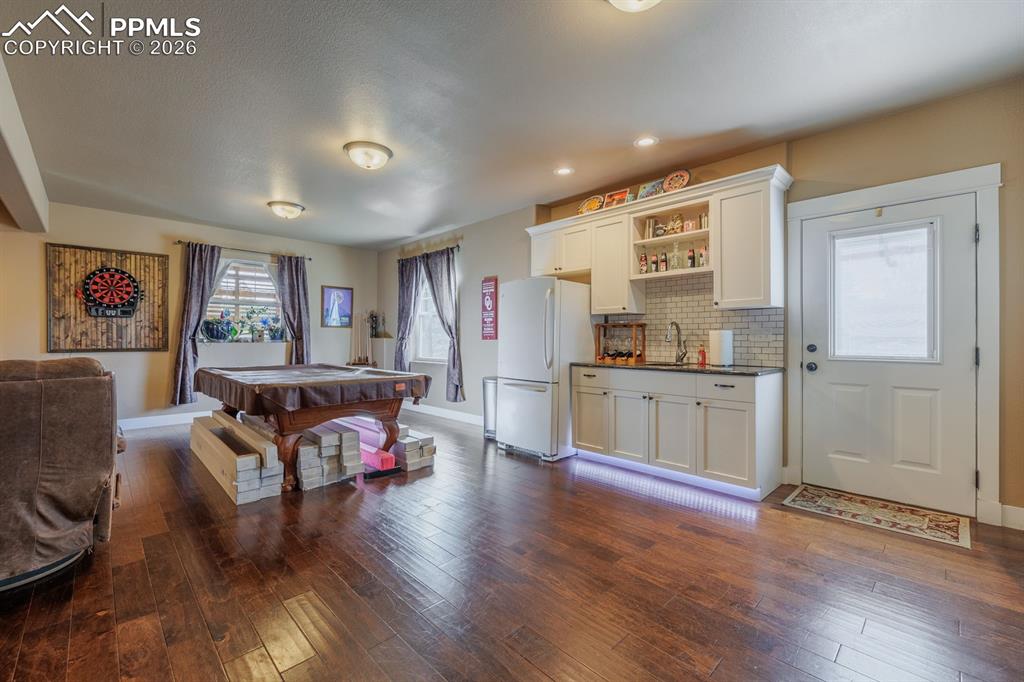 Wet bar plus a full size fridge. Door gives access to the ground level with additional parking. Easy set-up multi-generational living quarters.