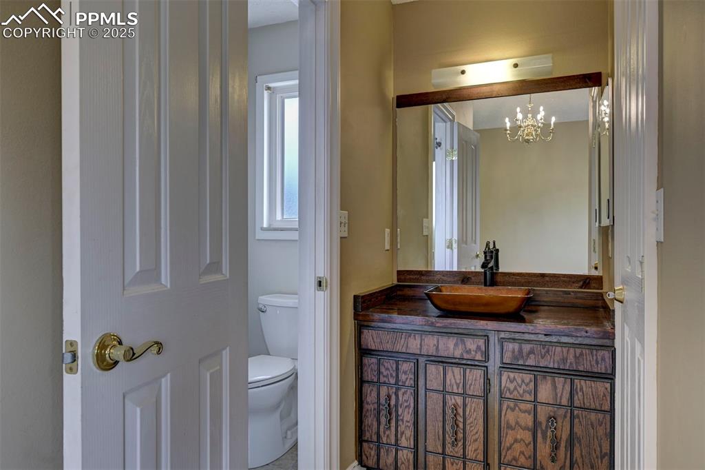 Bathroom featuring vanity and a chandelier
