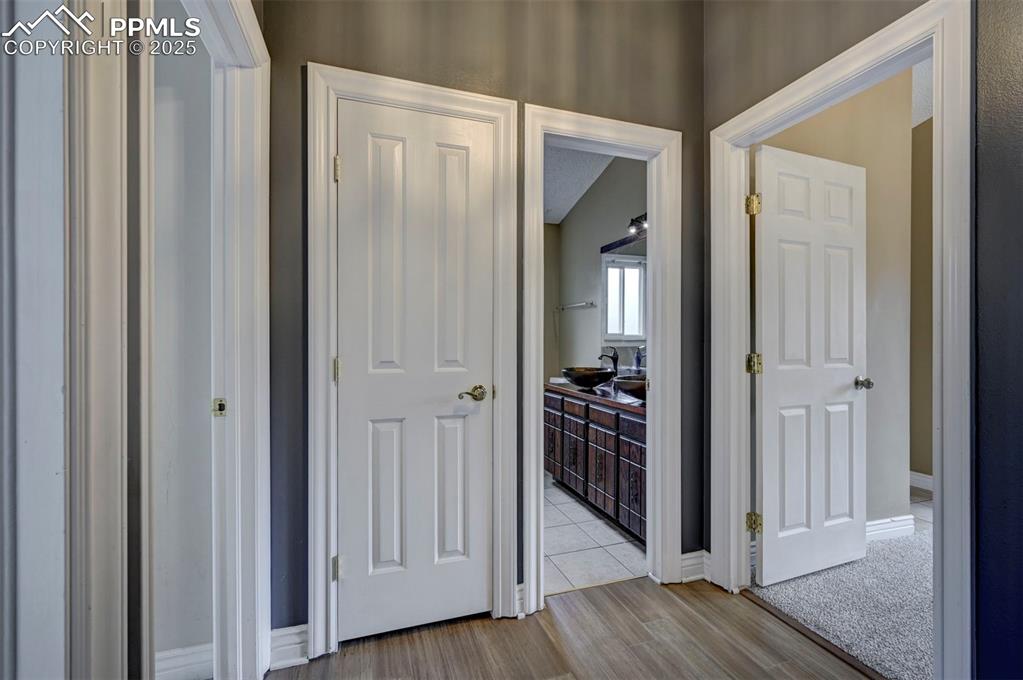 Hall with light wood-type flooring and baseboards