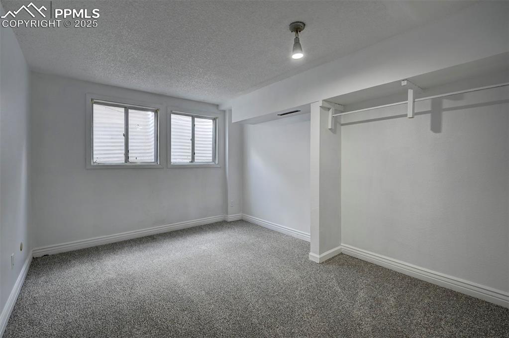 Unfurnished bedroom featuring carpet flooring and a textured ceiling