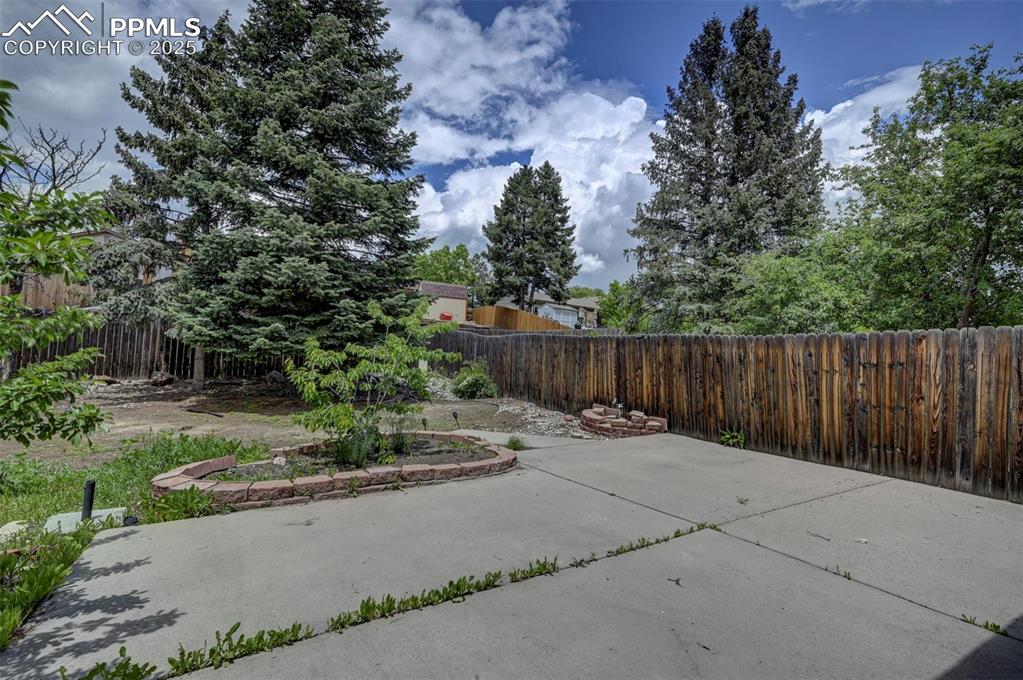 Fenced backyard featuring a patio