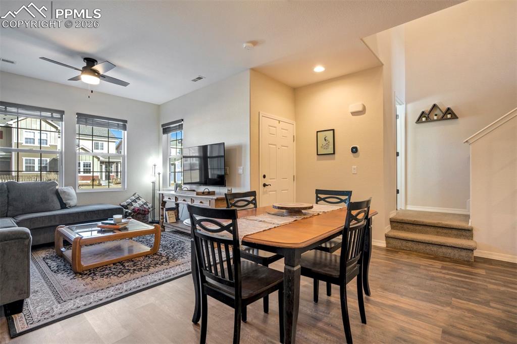 Dining area open to the living area.  Showing the front door and two steps up to the main level powder room.