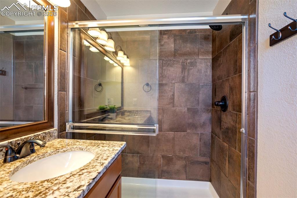 Primary bathroom showing the large shower and tile surround. 