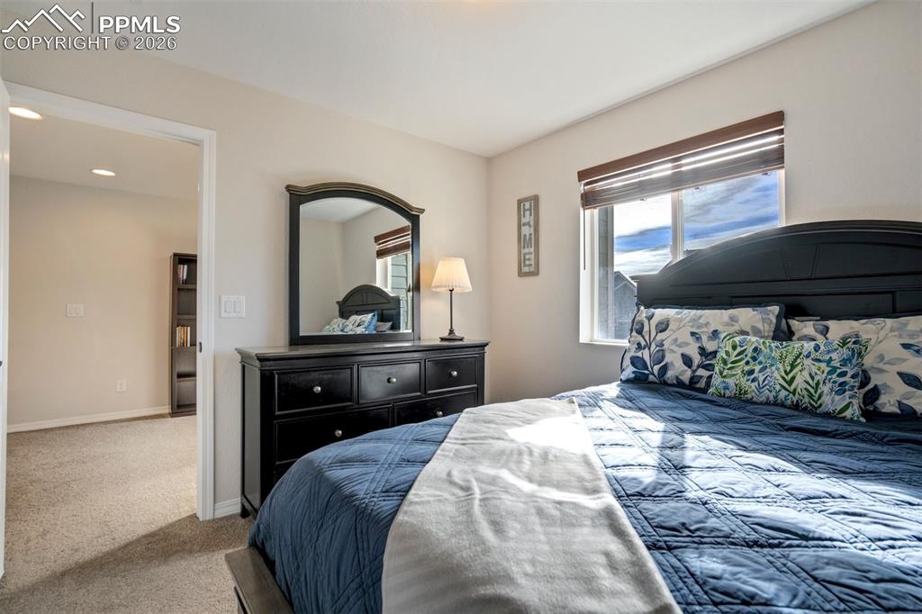 Another view of the second light filled bedroom showing the door to the loft area. 