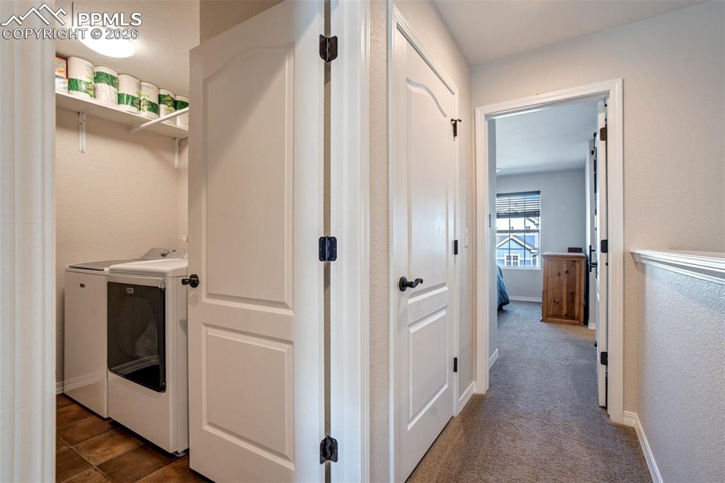 Laundry room with washer and dryer, included and tile floor. 