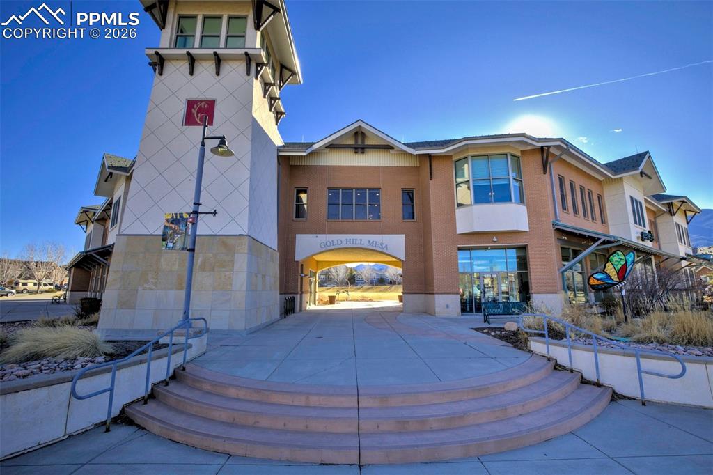 View of the Community Building where the gym is located and the green park for summer enjoyment.  The gym is walking distance from the townhome. 