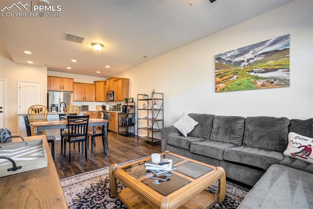 Living area showing the true open floor plan looking to the dining and kitchen areas. Same flooring throughout the main level. 