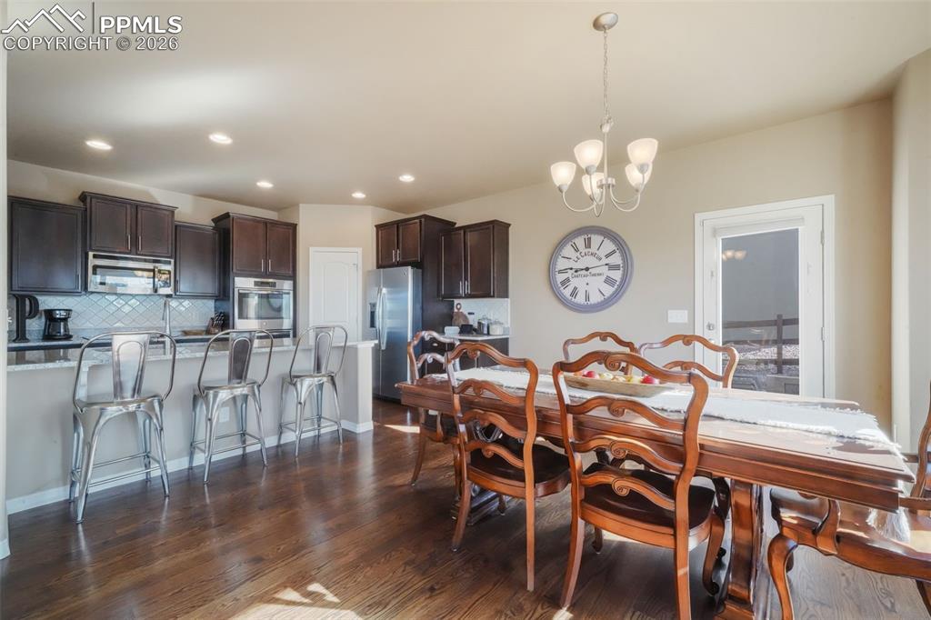 Dining area with hardwood floors, access to back patio and mountain views