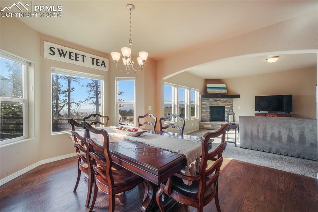 Dining area with hardwood floors, access to back patio and mountain views