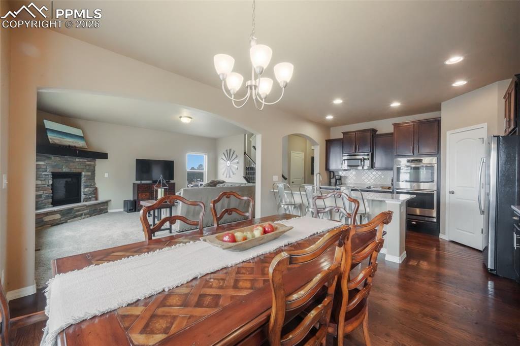 Dining area with hardwood floors, access to back patio and mountain views
