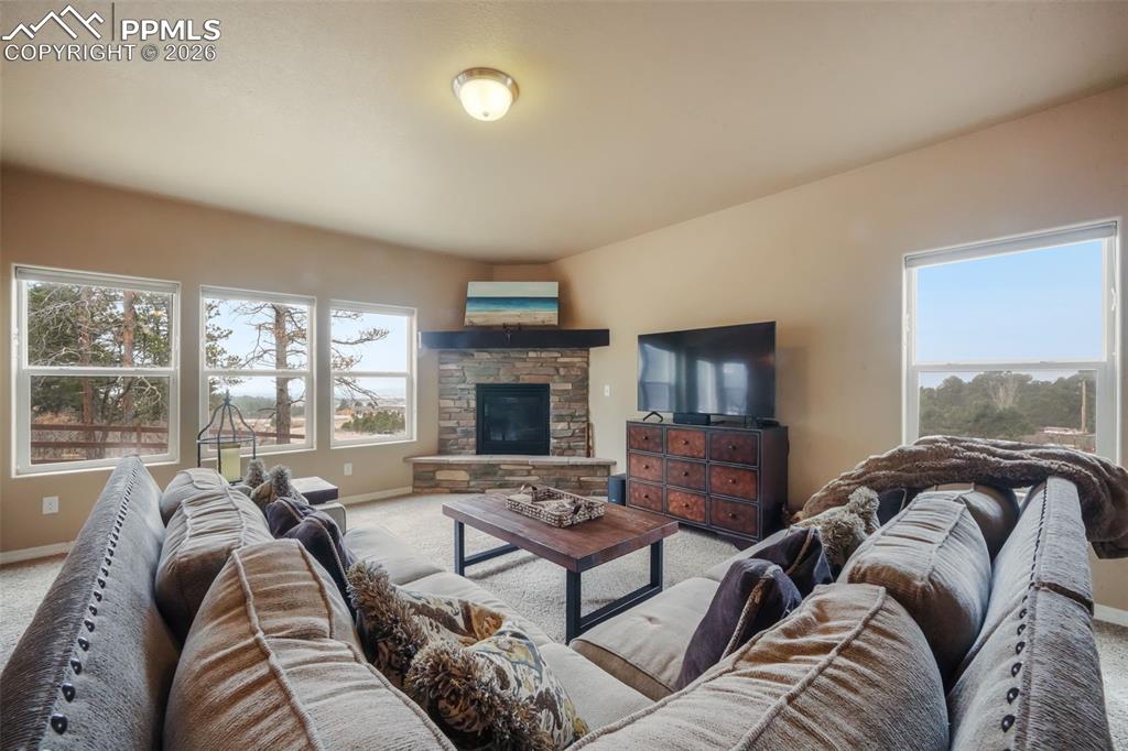 Open concept living room with mountain views, natural light and gas fireplace