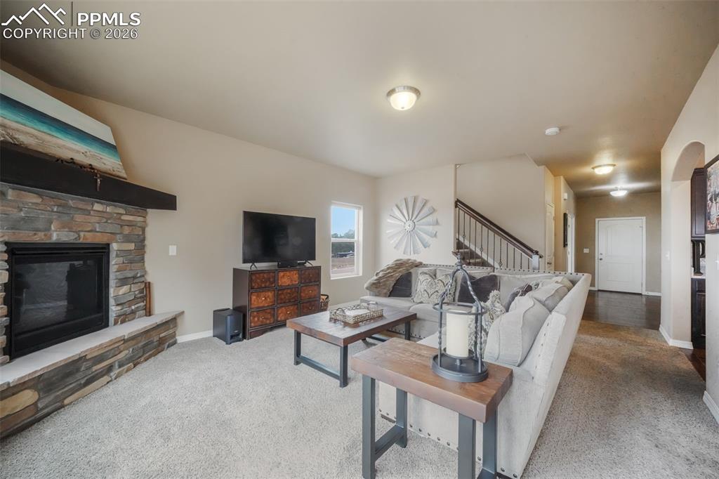Open concept living room with mountain views, natural light and gas fireplace