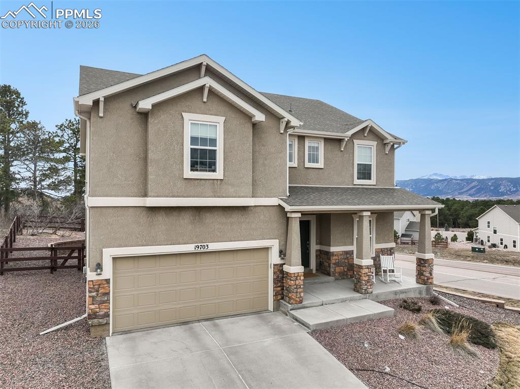 ront of home with mountain views and long driveway