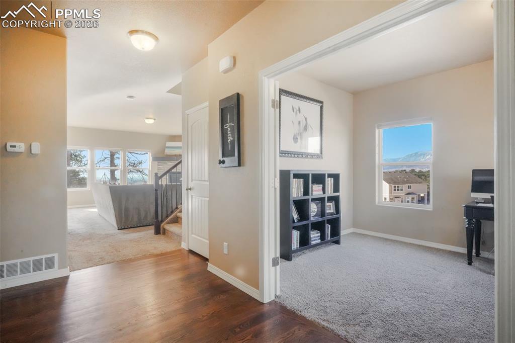 Hardwood entry with access into main floor office with mountain views