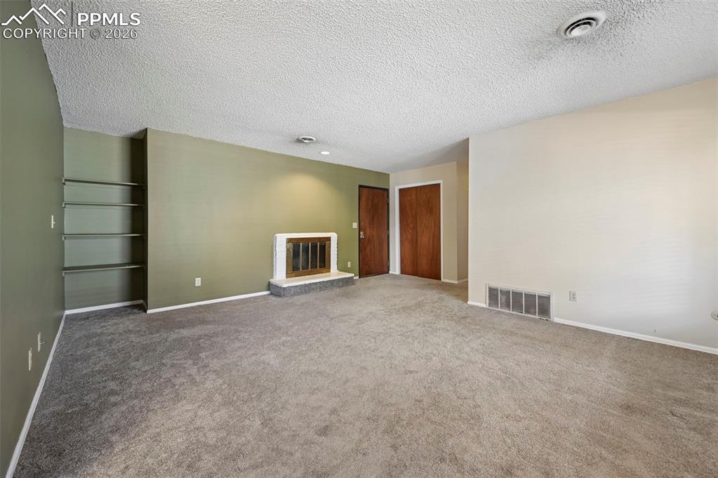 Living room with fireplace and built in shelving
