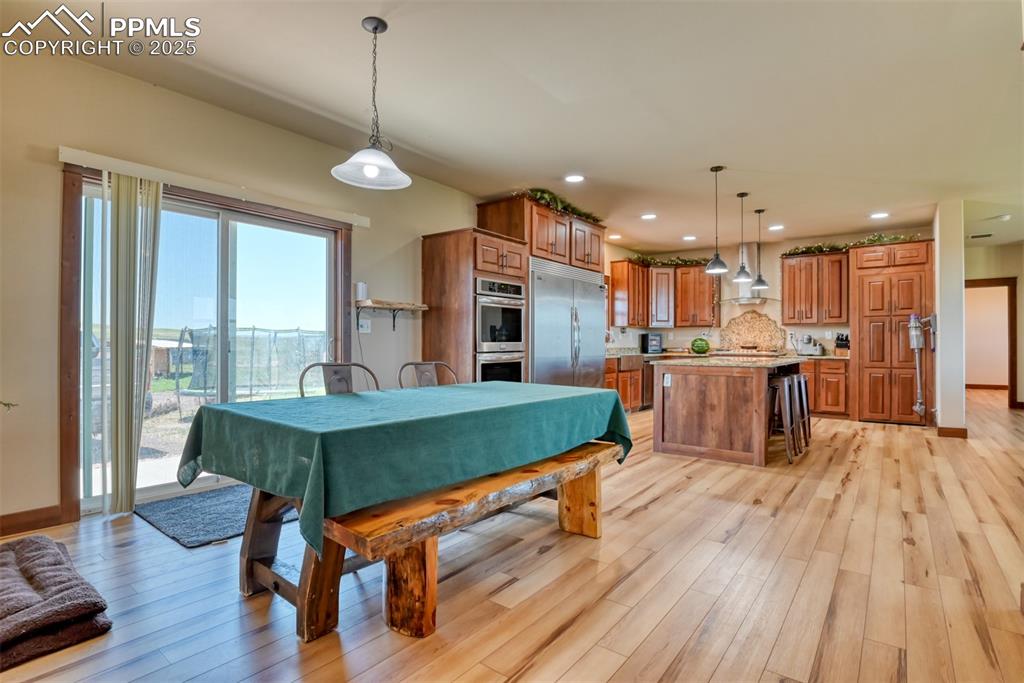 Dining room featuring light wood finished floors and recessed lighting