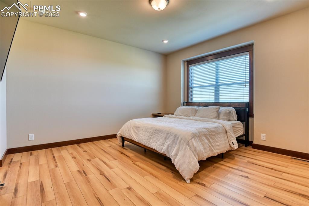 Bedroom featuring light wood-type flooring and recessed lighting