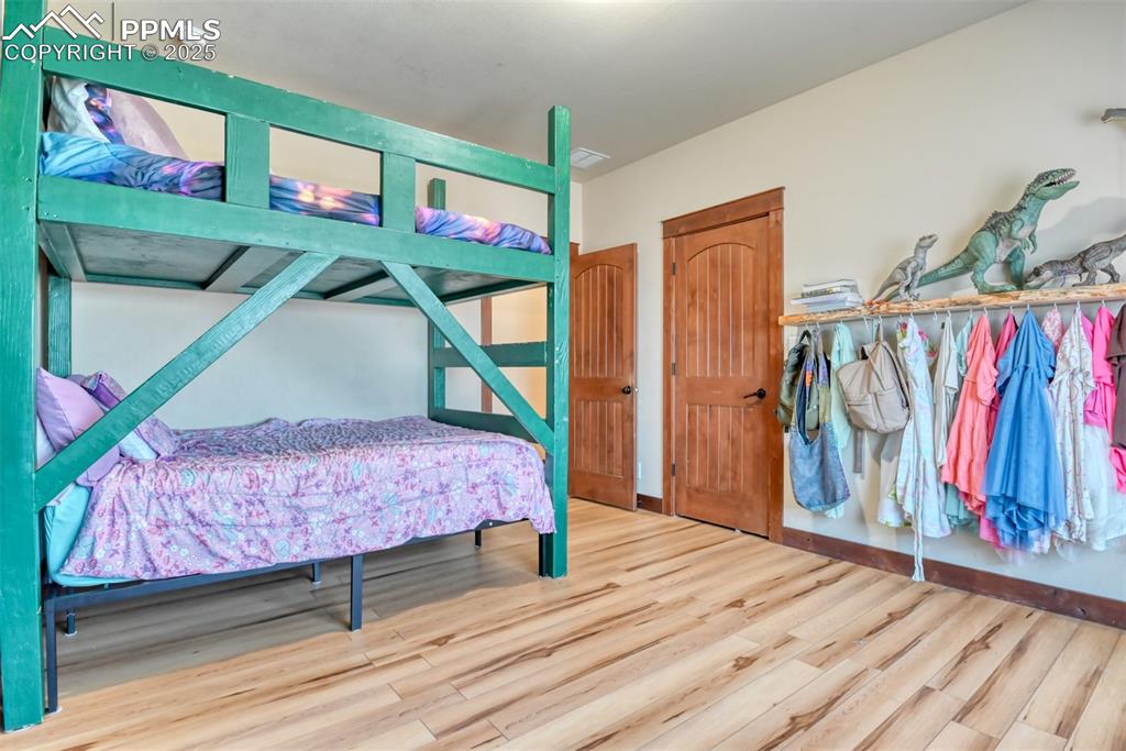 Bedroom featuring LVT wood style floors