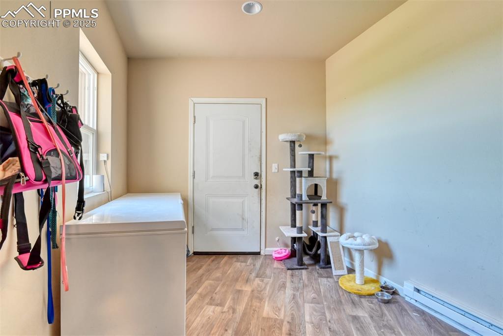 Entry/Mud room featuring a baseboard radiator and LVT wood style flooring