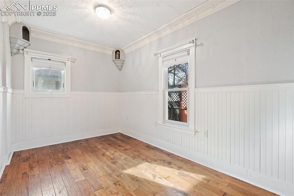 2nd Bedroom in main home with hickory wood floors and Andersen windows 