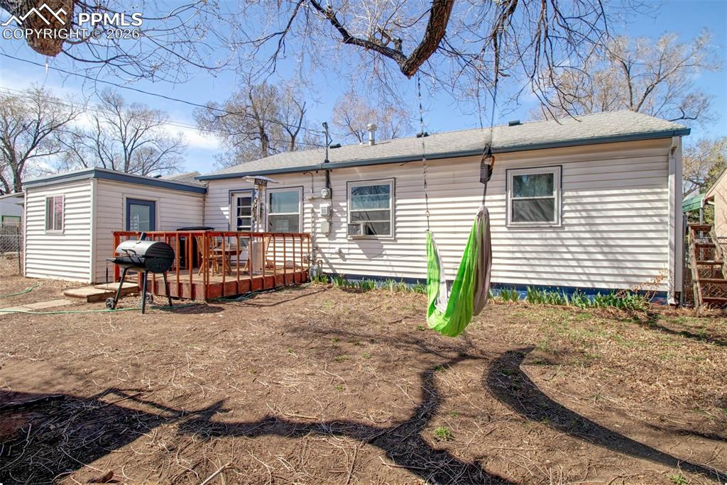 Another view of the backyard showin entrance to the apartment and small deck