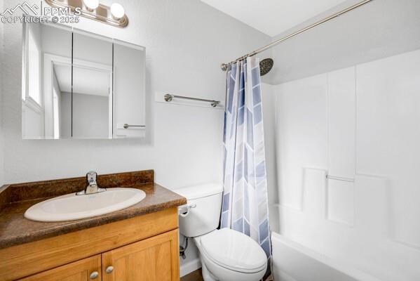 Bathroom with shower / bath combination with curtain and vanity