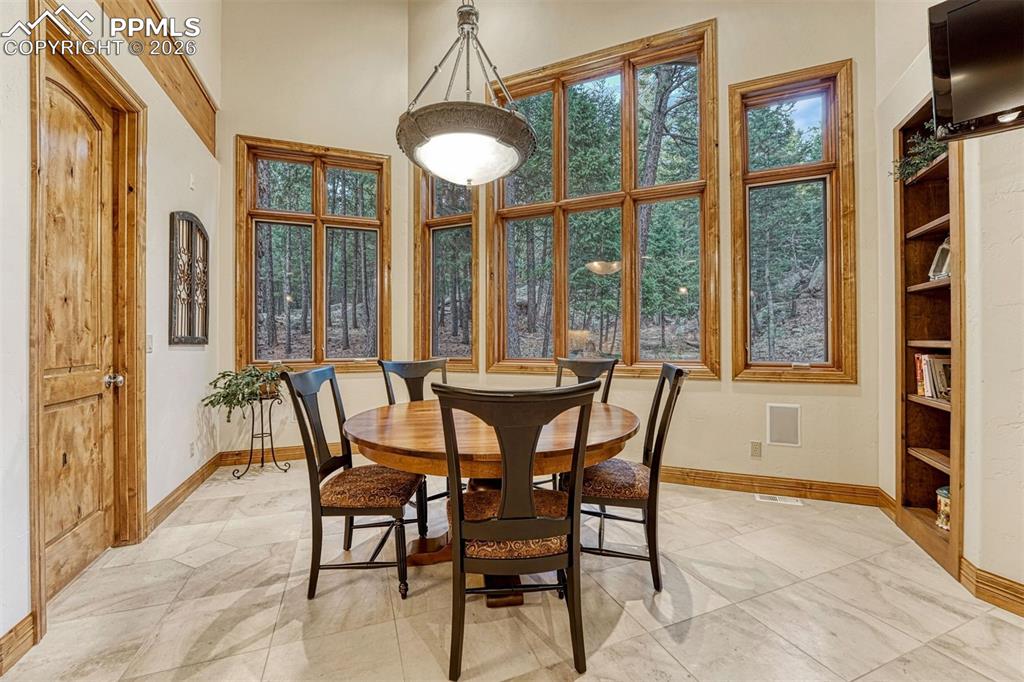 Breakfast nook framed by backyard greenery.