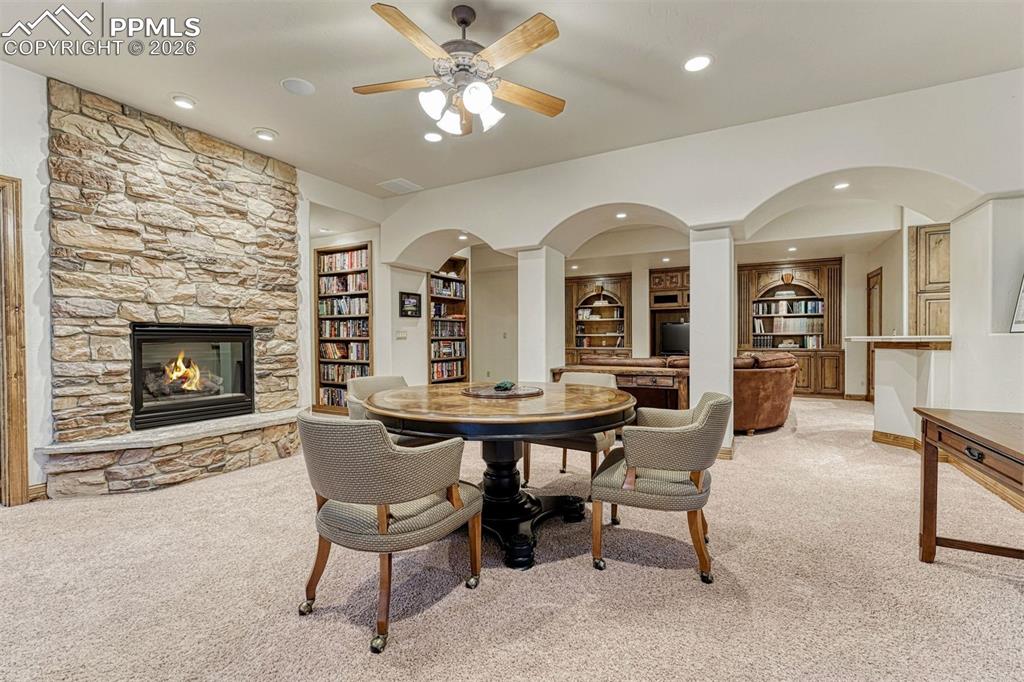 Designed for comfort, the lower level features a gas fireplace, built in bookshelves, and beautiful architectural details.