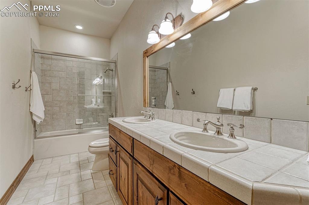 Generous guest suite bath with dual sink vanity.