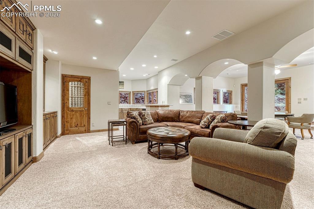 A sophisticated lower level with custom built-ins, media area, wine cellar, and expansive wet bar for effortless entertaining.
