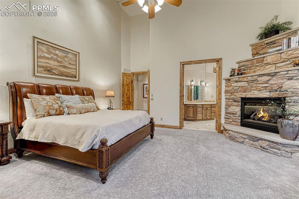 Primary bedroom with a cozy, elegant gas fireplace.