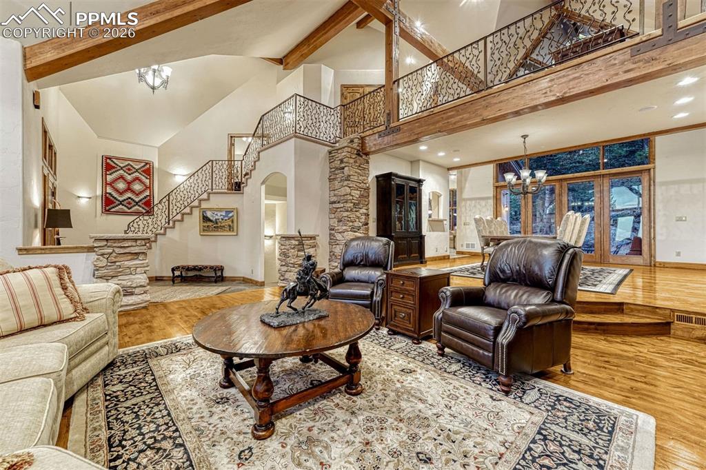 Soaring ceilings with exposed beams in the great room.
