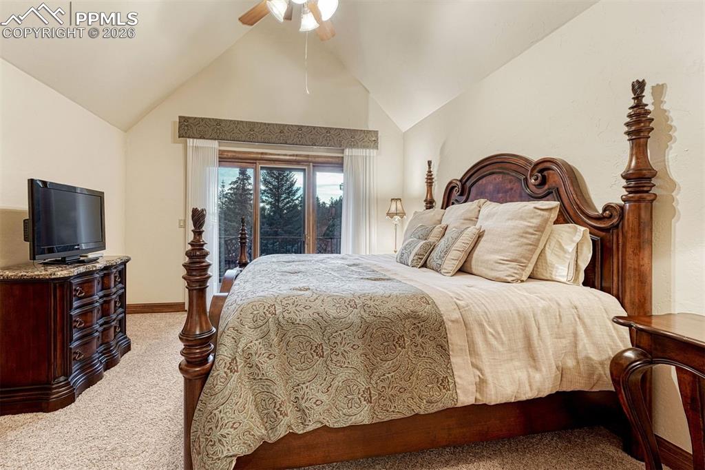 Upper-level bedroom with private balcony and scenic outlook.