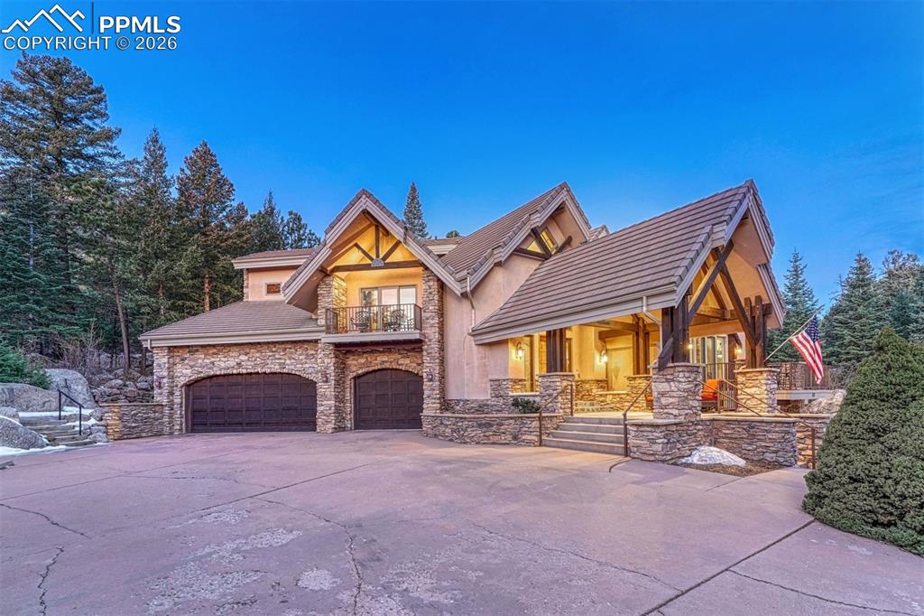 Three car garage with an expansive concrete driveway.