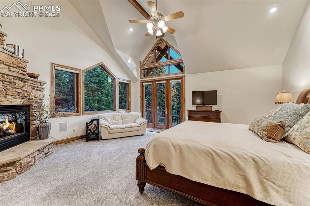 The primary bedroom opens to a private deck and is framed by stunning windows.