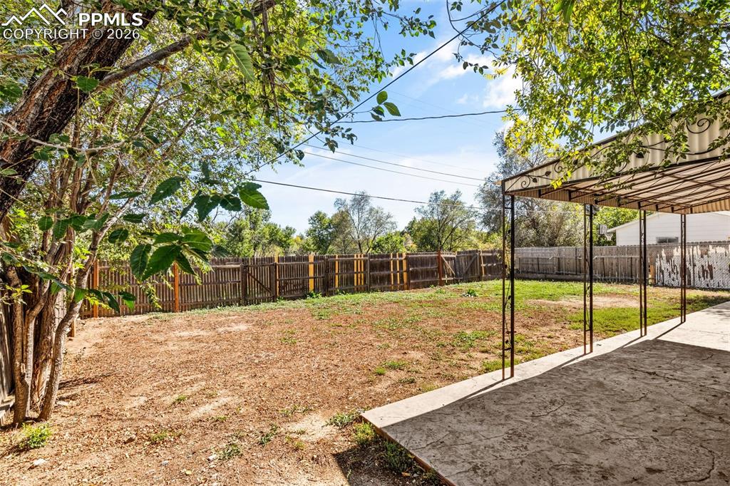 Fenced backyard with a patio area