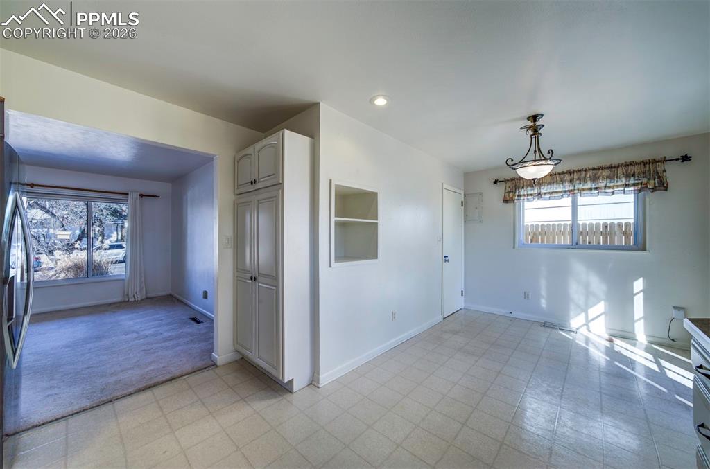 Dine in area and living room, from kitchen sink area; showing pantry area too; door goes to garage