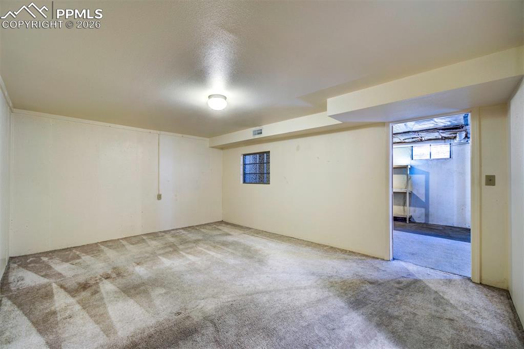 Another view of the non-conforming bedroom and out into open basement/storage area