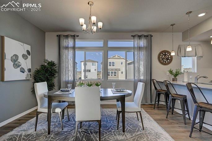 Dining room featuring wood finished floors and a chandelier