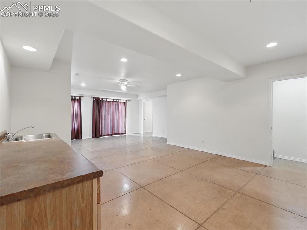Unfurnished room with ceiling fan, recessed lighting, and light tile patterned floors