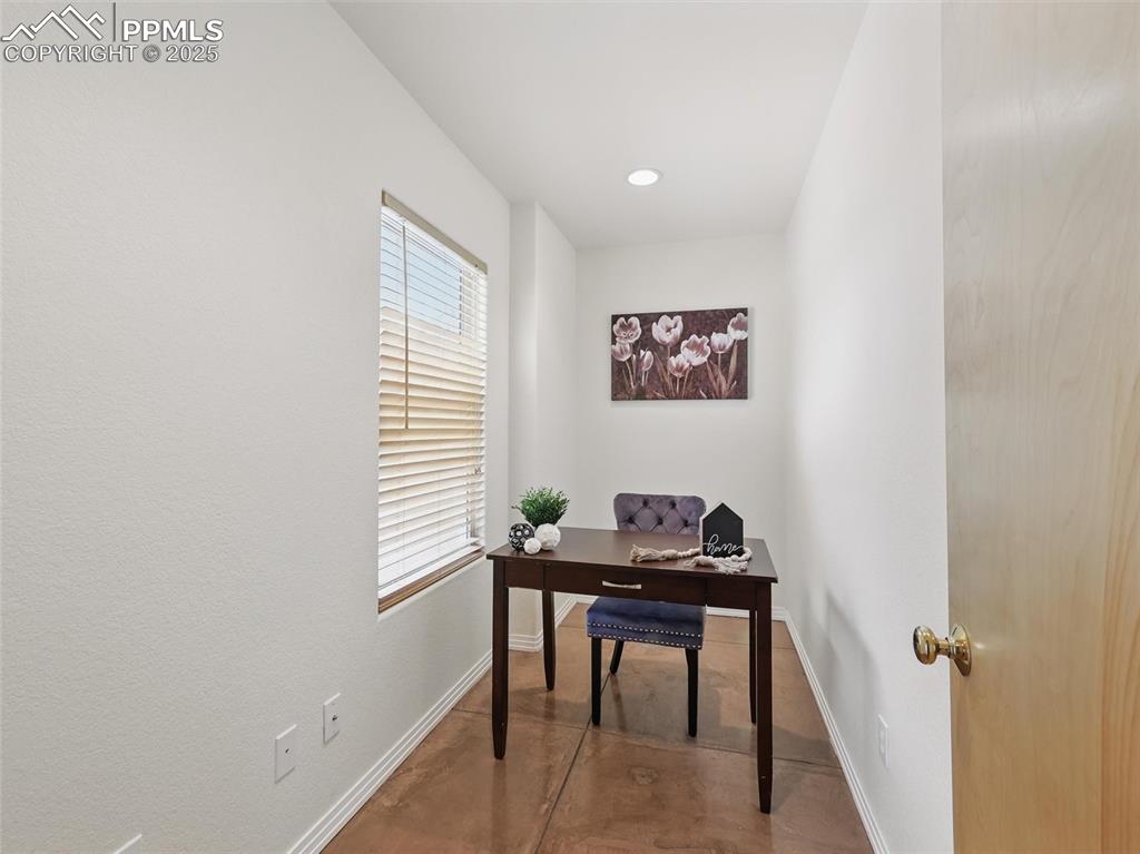 Office space with recessed lighting and concrete flooring