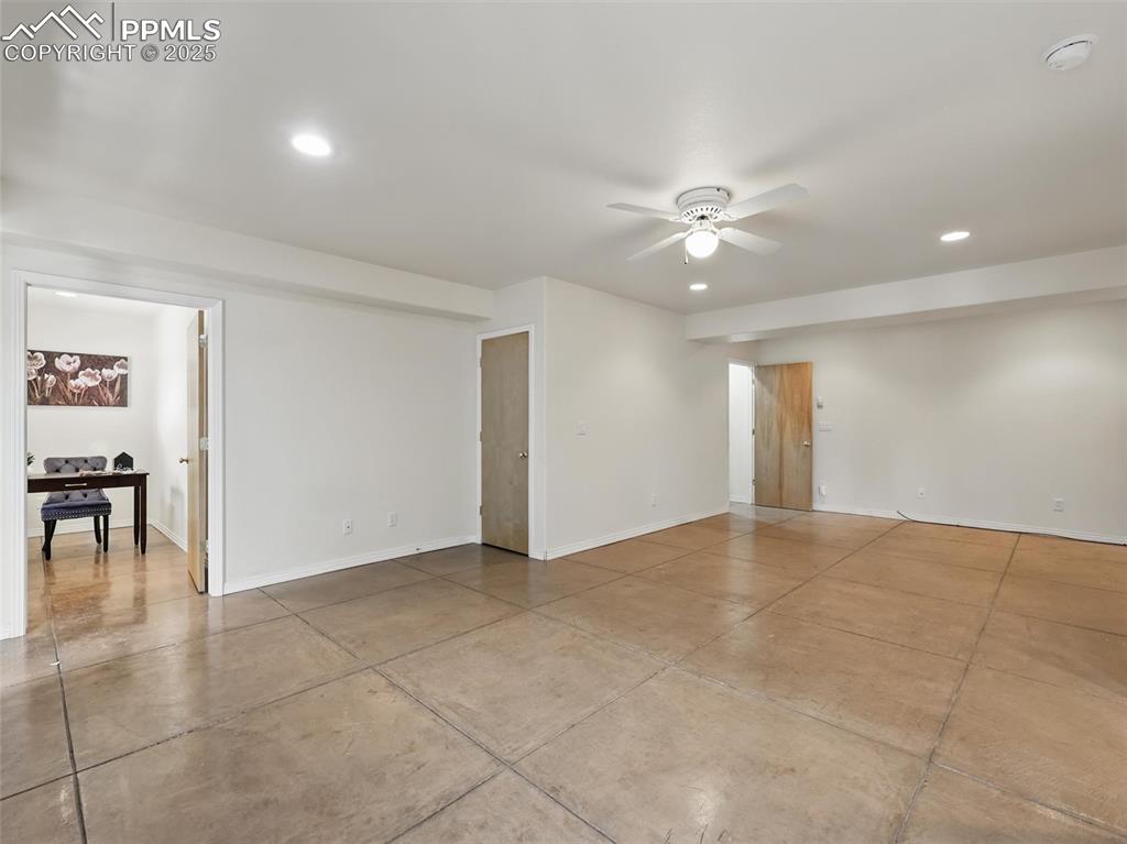 Spare room featuring recessed lighting, ceiling fan, and concrete flooring