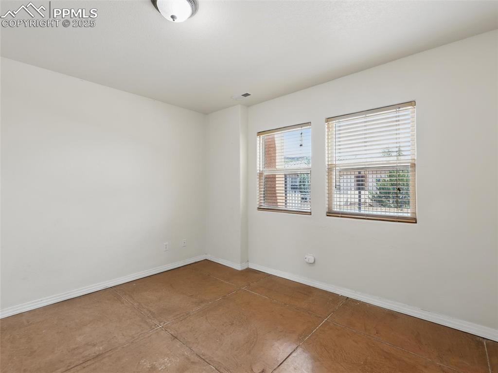 Unfurnished room with baseboards