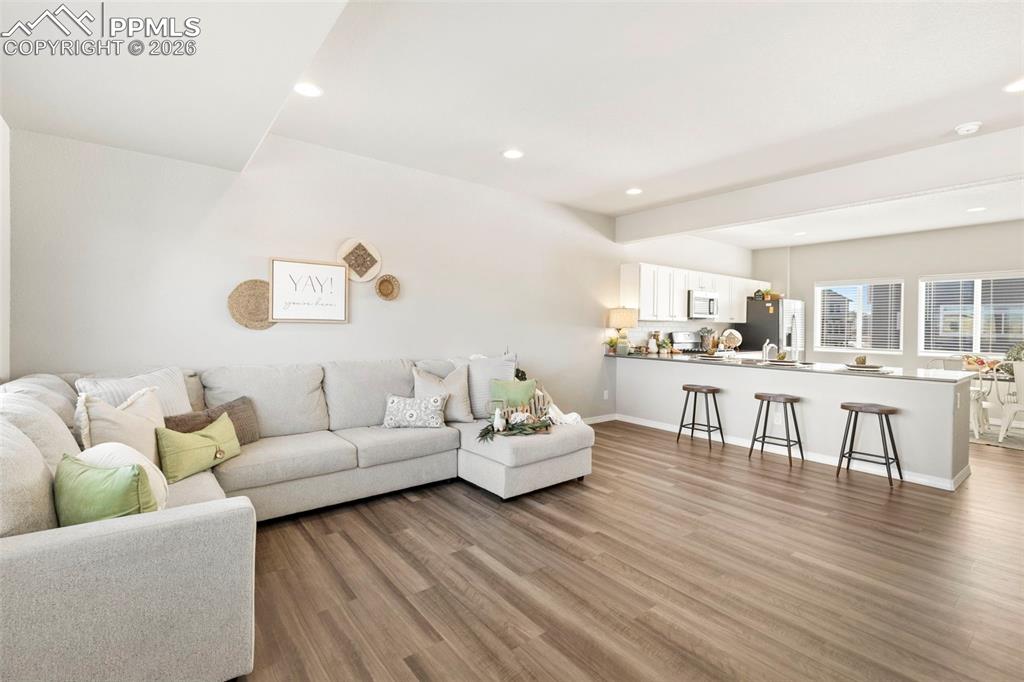 Open to kitchen/dining.