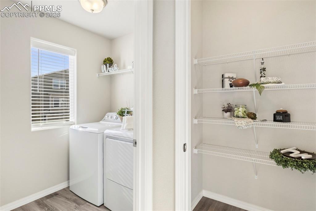Roomy laundry area with window and view of pantry.