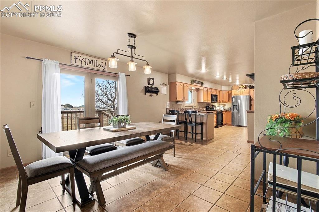 Dining room featuring plenty of natural light and light tile patterned floors