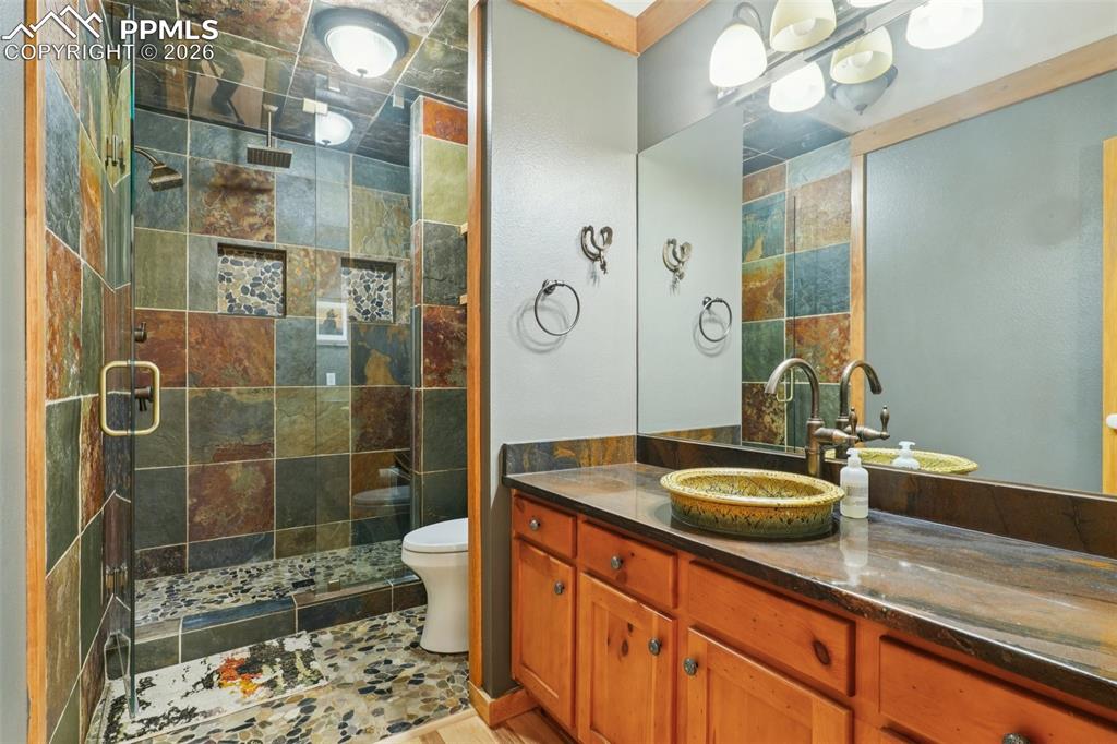 3/4 bath featuring vanity and a tile shower on main floor