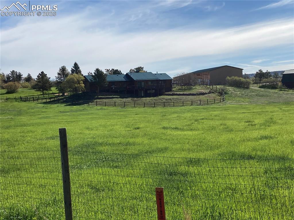 View of yard with a rural view in summer