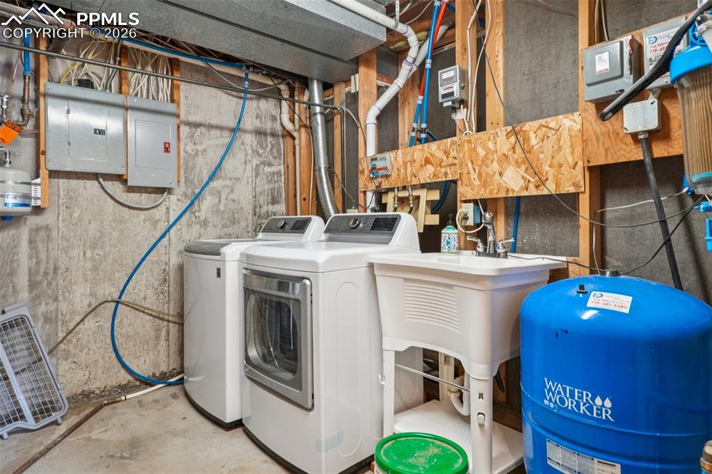 Laundry area featuring electric panel, and separate washer and dryer